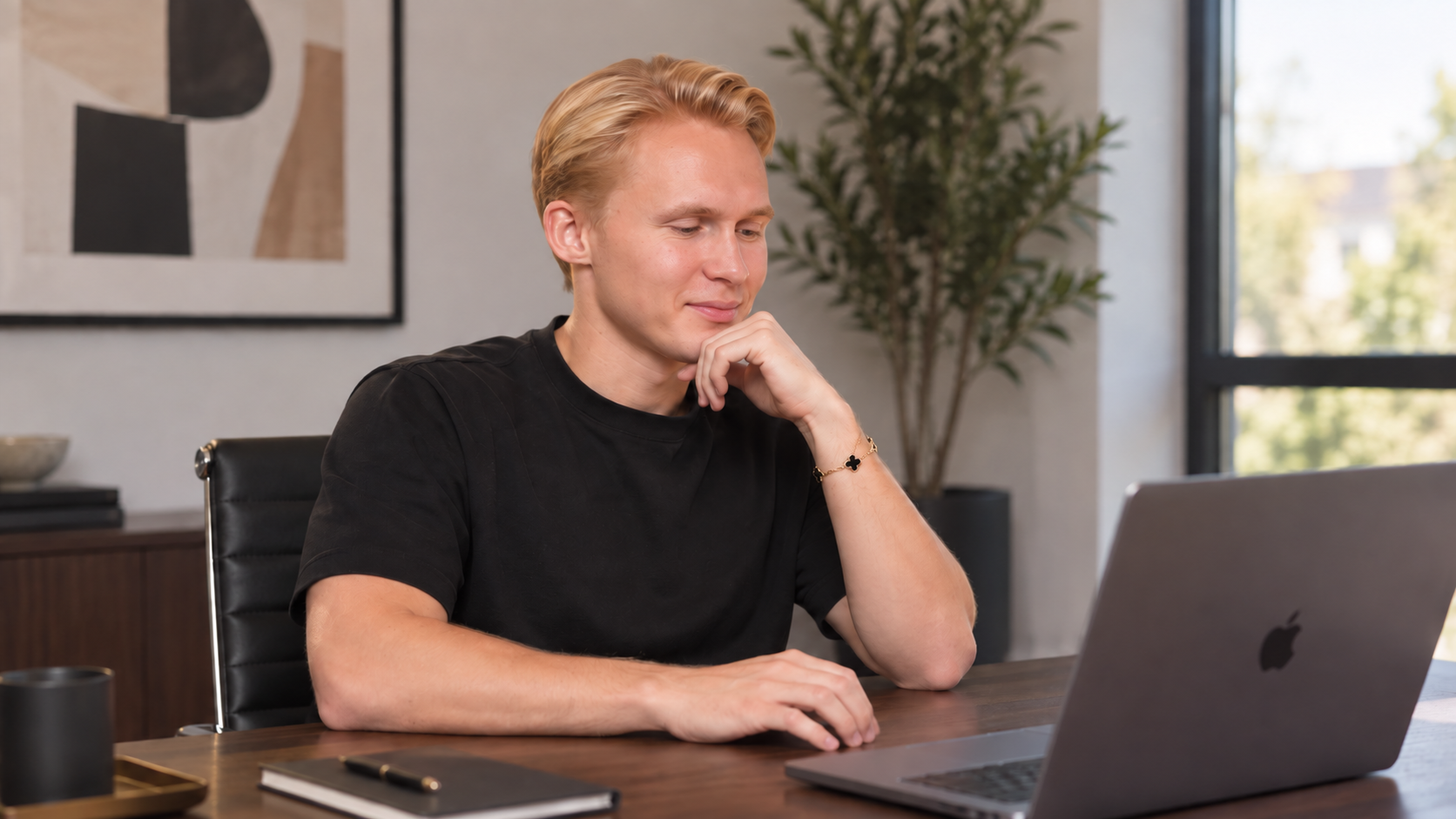 Leo studying a faceless YouTube niche on his laptop